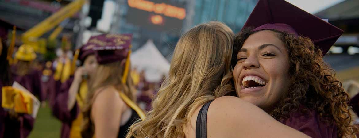 asu students hugging at graduation 